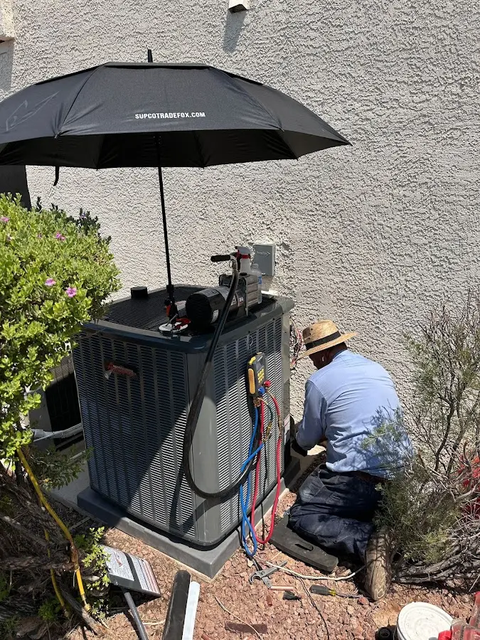 HVAC technician performing outdoor AC maintenance in Reisterstown