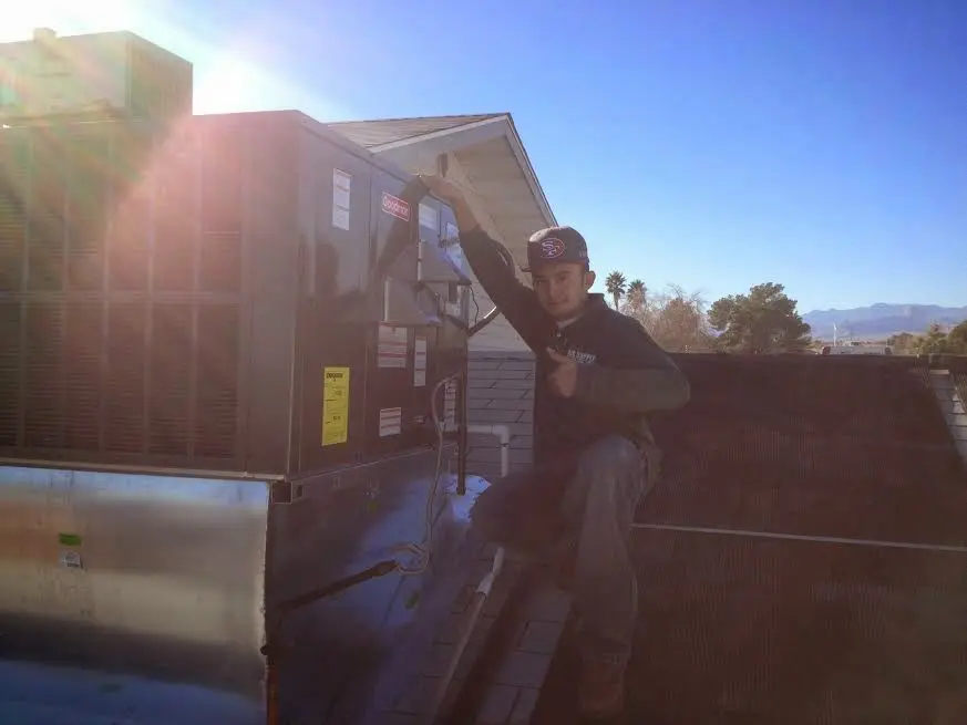 HVAC technician performing Boiler Repair on a rooftop unit in Reisterstown